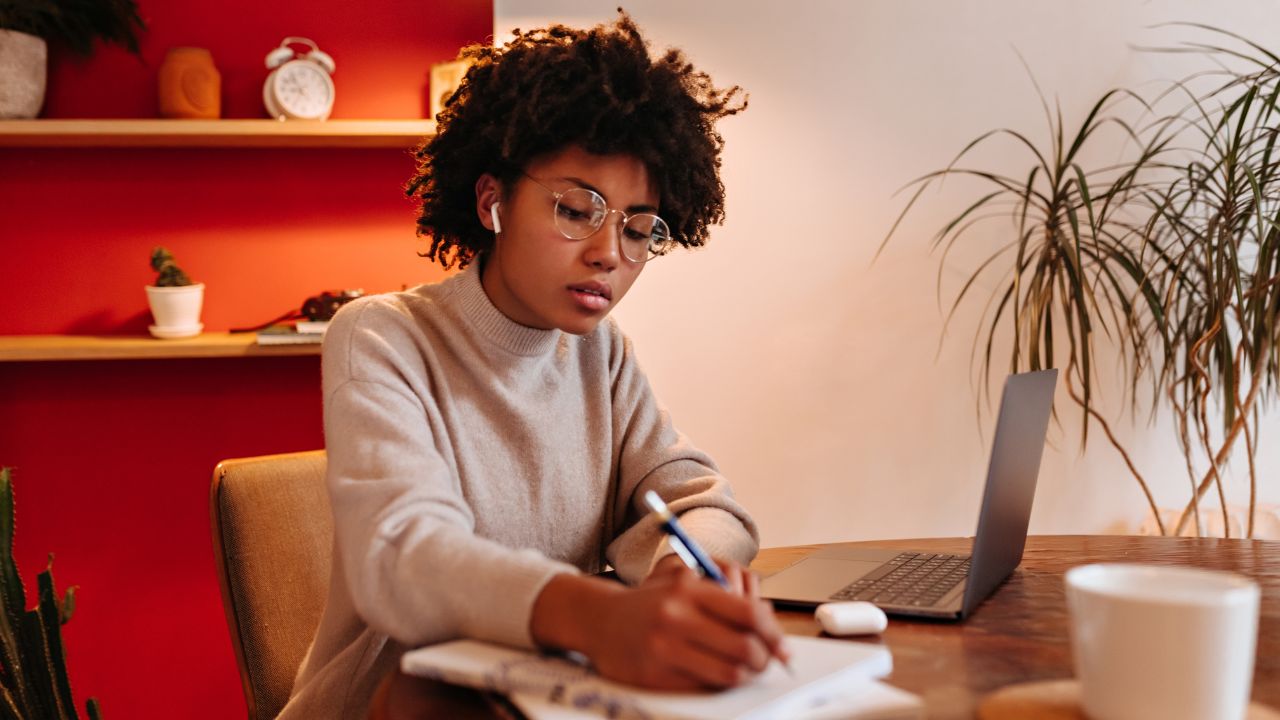 Photo of a woman writing down notes